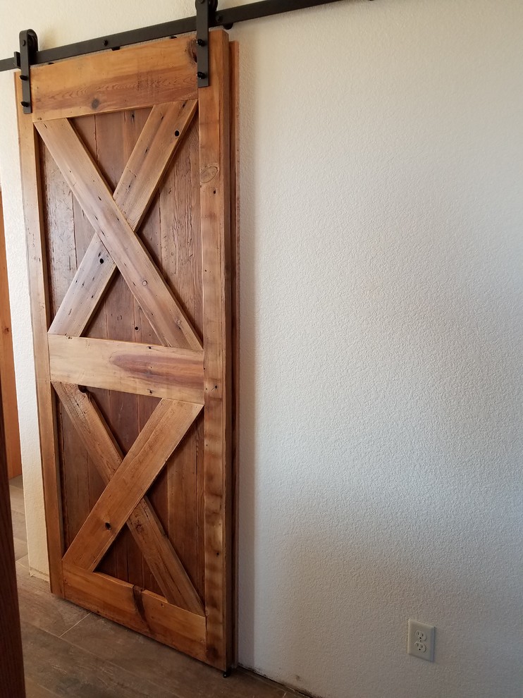 Example of a mid-sized mountain style medium tone wood floor and brown floor front door design in Denver with beige walls and a medium wood front door