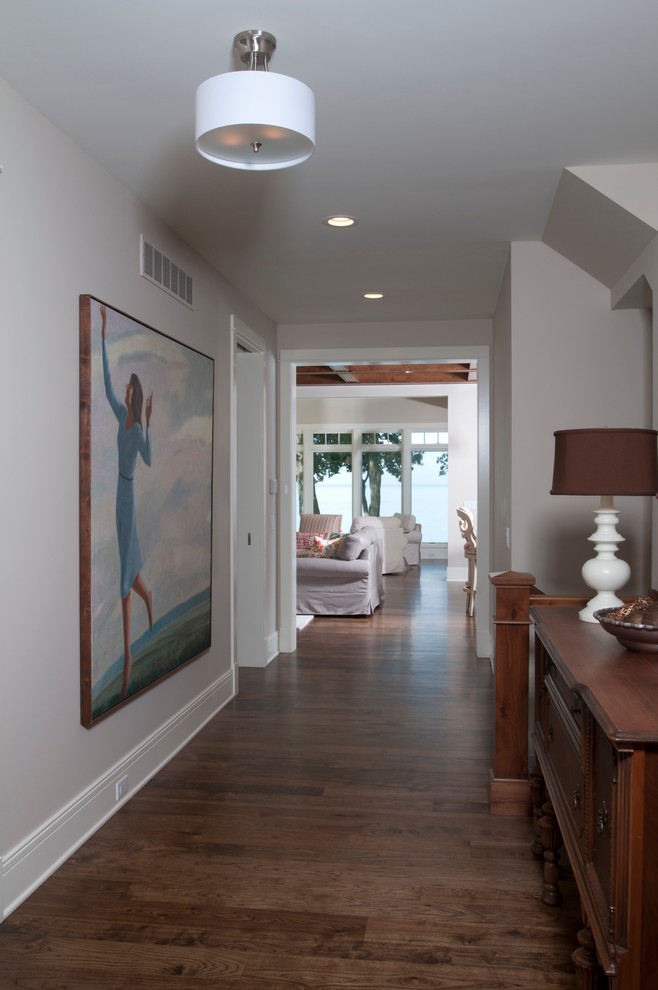 Photo of a mid-sized beach style hallway in Grand Rapids with grey walls and medium hardwood floors.
