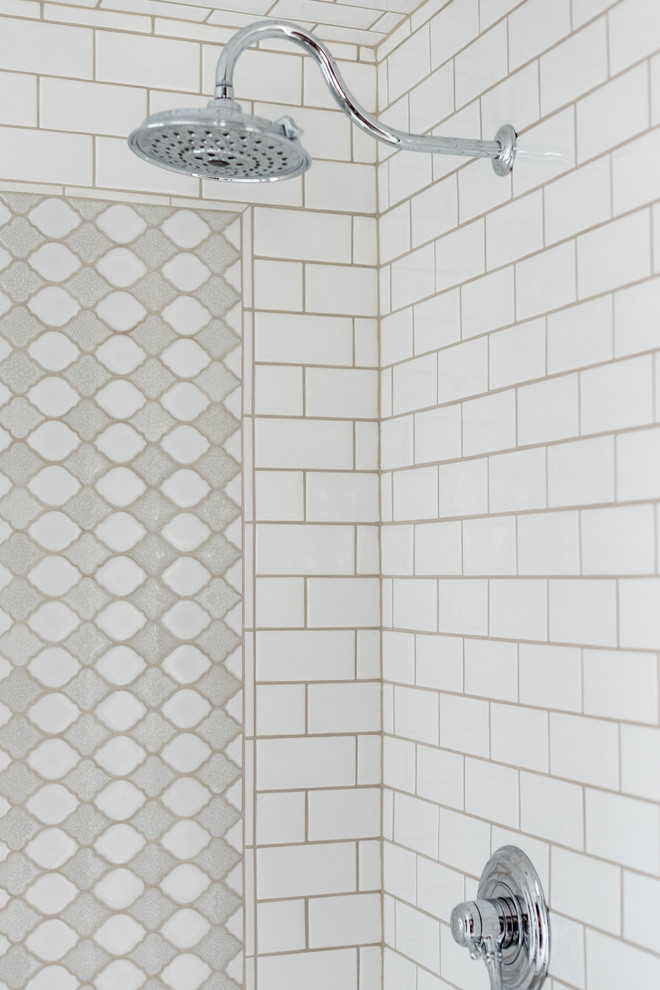 Inspiration for a mid-sized transitional 3/4 bathroom in Denver with a corner shower, white tile, subway tile, grey walls, an undermount sink, solid surface benchtops and a hinged shower door.