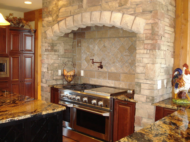 Inspiration for a large rustic u-shaped medium tone wood floor open concept kitchen remodel with beaded inset cabinets, dark wood cabinets, granite countertops, beige backsplash, stainless steel appliances and an island