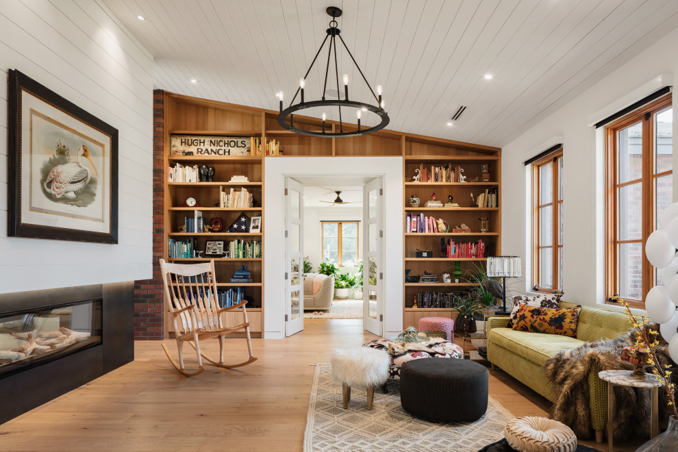 Mid-sized trendy enclosed medium tone wood floor and wood ceiling family room photo in Phoenix with a two-sided fireplace and a shiplap fireplace