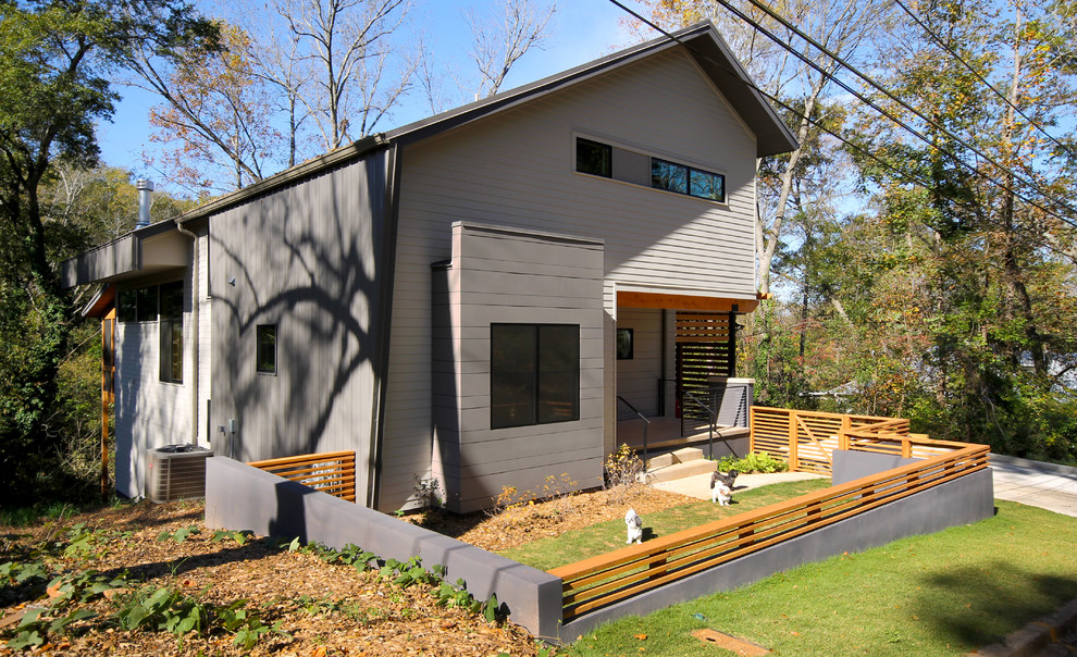 This is an example of a contemporary two-storey grey exterior in Atlanta with metal siding.