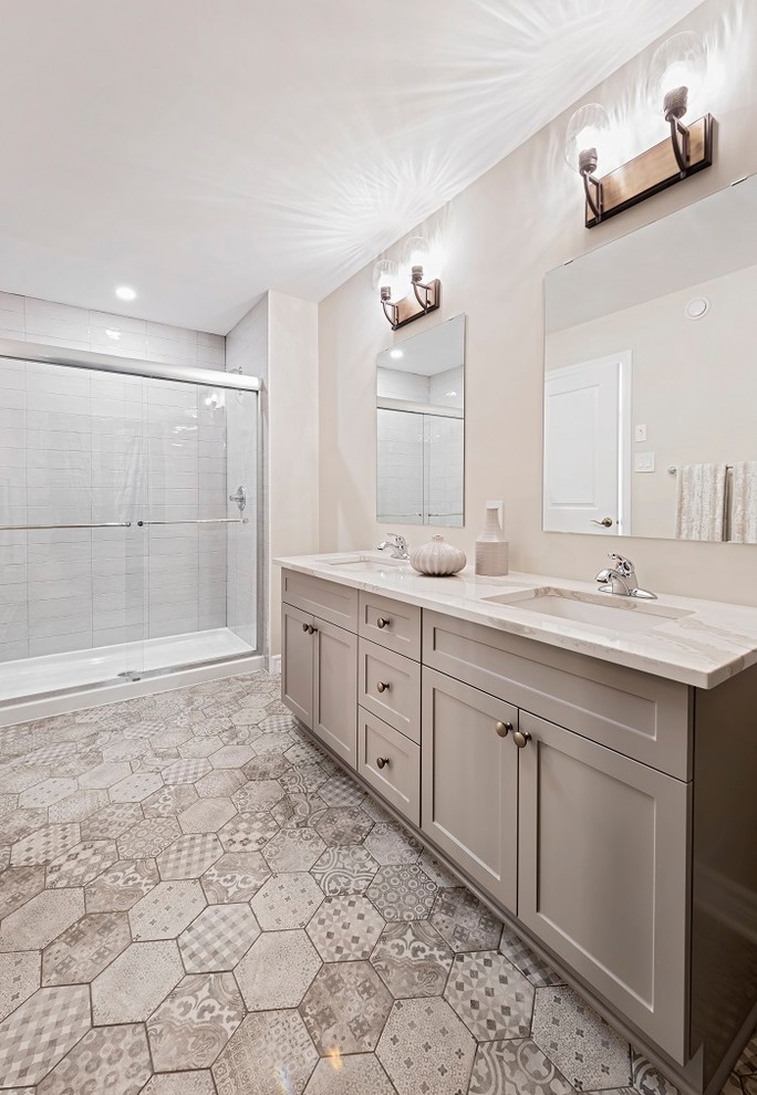 Large transitional master bathroom in Ottawa with recessed-panel cabinets, beige cabinets, a double shower, a two-piece toilet, white tile, ceramic tile, beige walls, ceramic floors, an undermount sink, engineered quartz benchtops, beige floor, a sliding shower screen and beige benchtops.