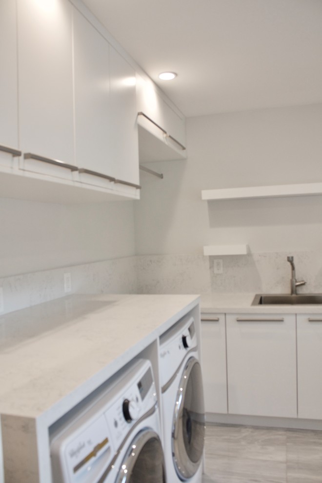 Inspiration for a large modern galley utility room in Miami with an utility sink, flat-panel cabinets, white cabinets, quartz benchtops, white walls, marble floors and a side-by-side washer and dryer.