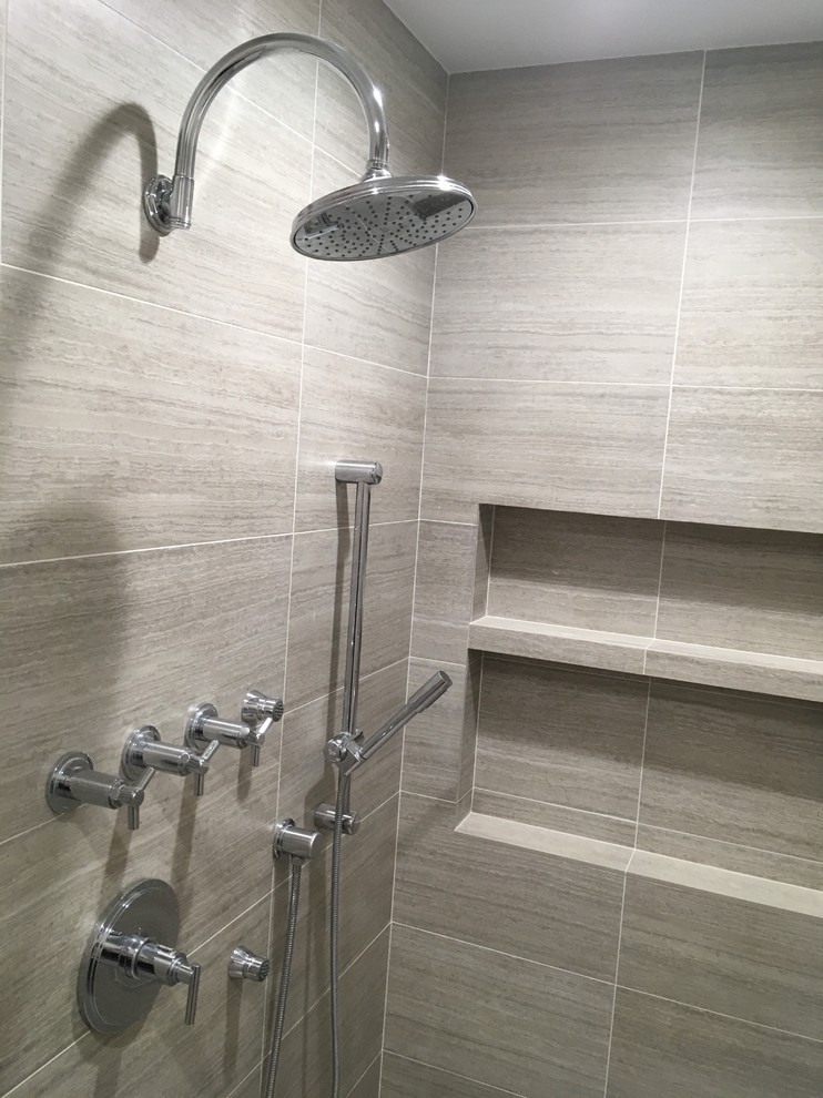 Mid-sized contemporary master bathroom in Chicago with flat-panel cabinets, dark wood cabinets, a freestanding tub, a double shower, a one-piece toilet, multi-coloured tile, cement tile, beige walls, travertine floors, an undermount sink, engineered quartz benchtops, beige floor, a hinged shower door and white benchtops.