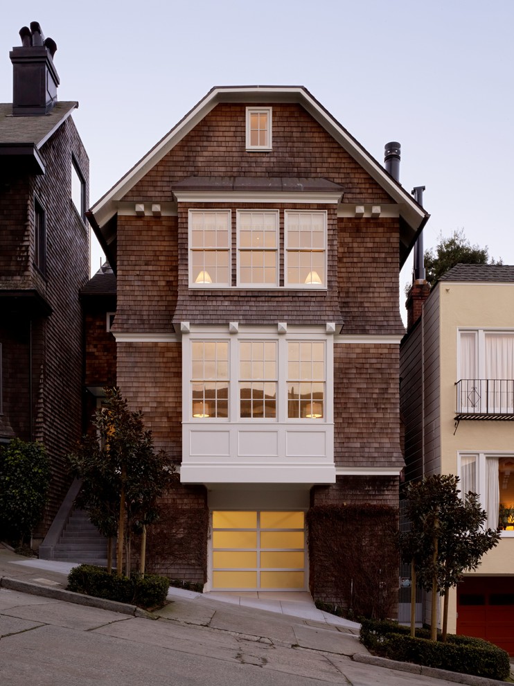 Photo of a large traditional three-storey townhouse exterior in San Francisco with wood siding and a clipped gable roof.