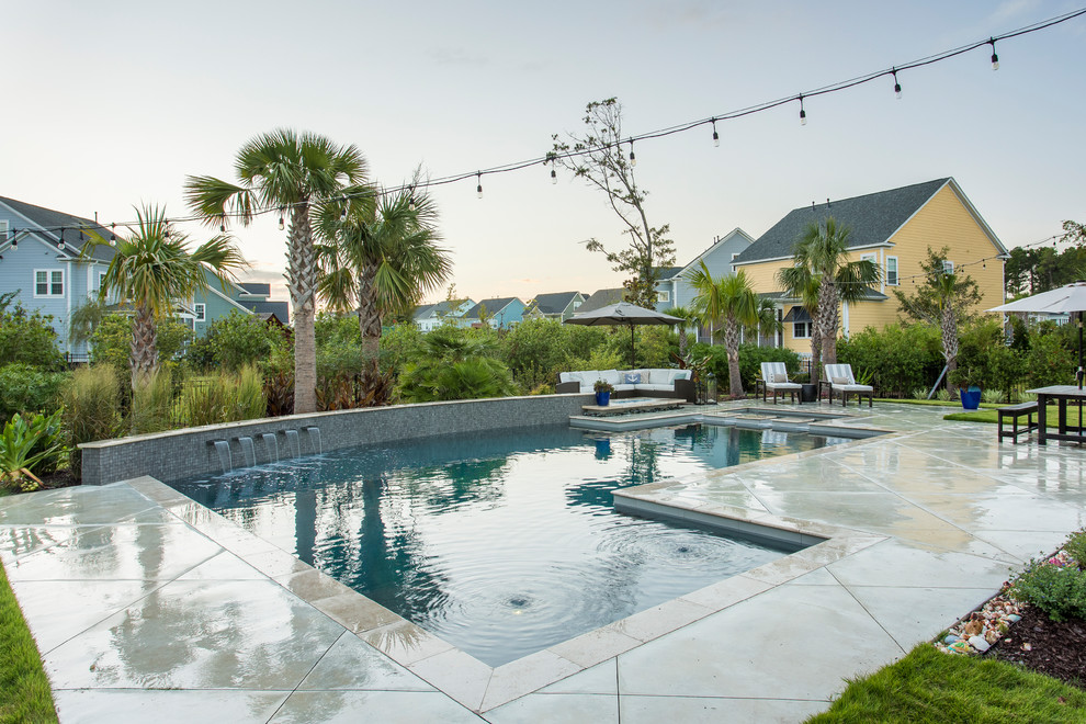 Design ideas for a beach style backyard custom-shaped lap pool in Charleston with a water feature and concrete slab.