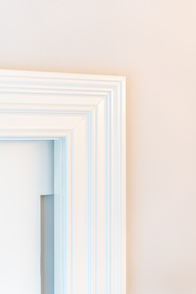 Close-Up of White Door Frame Against Cream Painted Wall