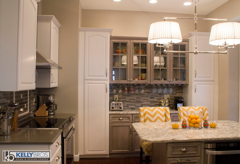 Inspiration for a mid-sized transitional u-shaped dark wood floor eat-in kitchen remodel in Cincinnati with an undermount sink, flat-panel cabinets, gray cabinets, quartz countertops, gray backsplash, glass tile backsplash, stainless steel appliances and an island