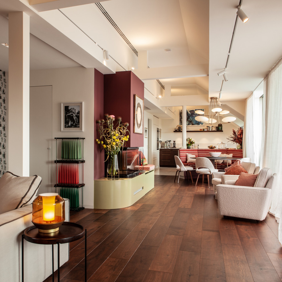 Inspiration for an expansive eclectic formal open concept living room in Hamburg with red walls, medium hardwood floors, a standard fireplace, a wood fireplace surround, a concealed tv, brown floor and recessed.