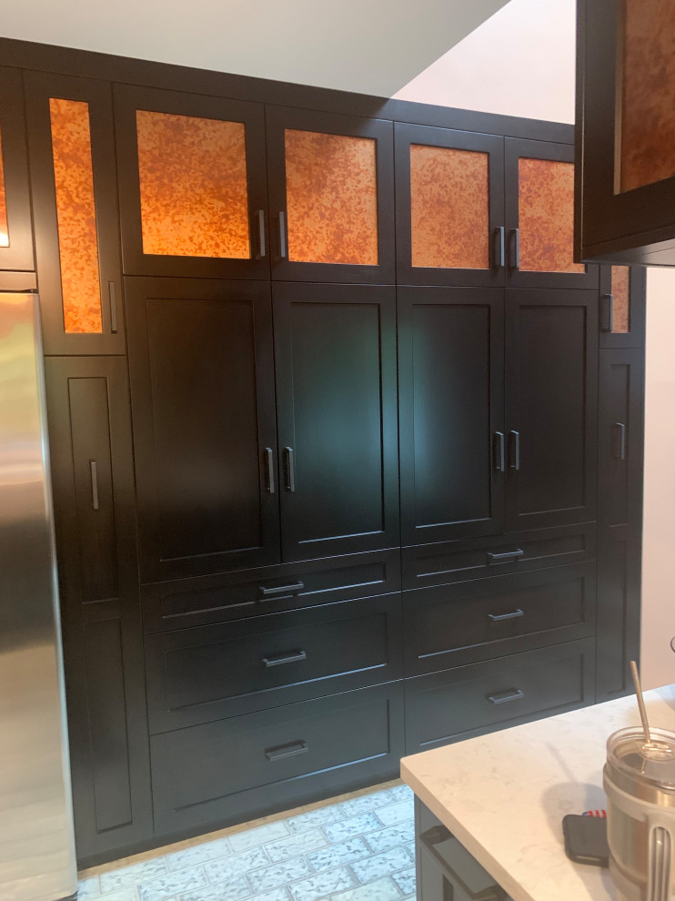 Enclosed kitchen - small transitional u-shaped ceramic tile and multicolored floor enclosed kitchen idea in Indianapolis with a double-bowl sink, recessed-panel cabinets, black cabinets, quartz countertops, gray backsplash, ceramic backsplash, stainless steel appliances, a peninsula and gray countertops