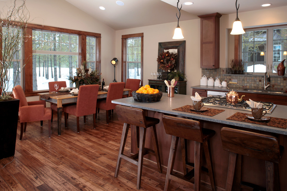 Mid-sized mountain style medium tone wood floor eat-in kitchen photo in Seattle with a double-bowl sink, shaker cabinets, medium tone wood cabinets, granite countertops, stone tile backsplash, stainless steel appliances and an island