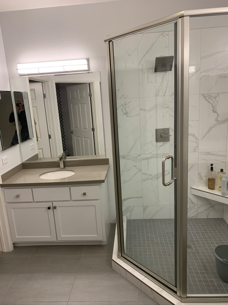 Photo of a mid-sized contemporary master bathroom in San Francisco with shaker cabinets, white cabinets, a corner shower, a one-piece toilet, white tile, porcelain tile, white walls, porcelain floors, an undermount sink, engineered quartz benchtops, grey floor, a hinged shower door, grey benchtops, a niche, a double vanity and a built-in vanity.
