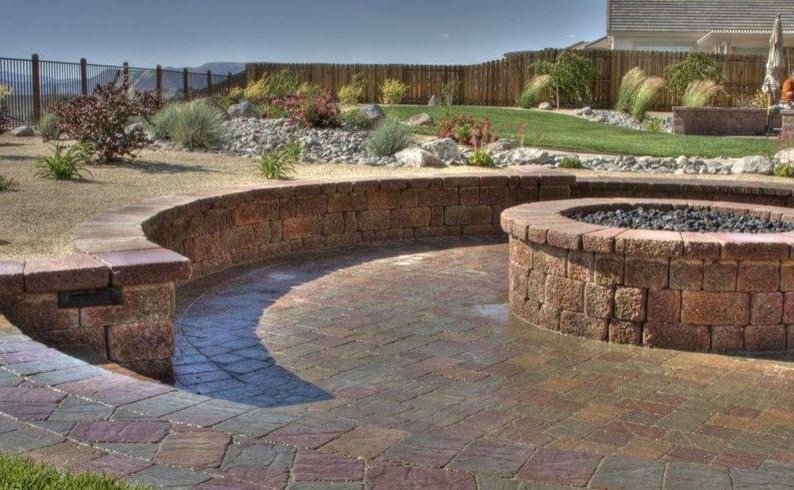 Design ideas for a mid-sized traditional backyard patio in Other with a fire feature and brick pavers.