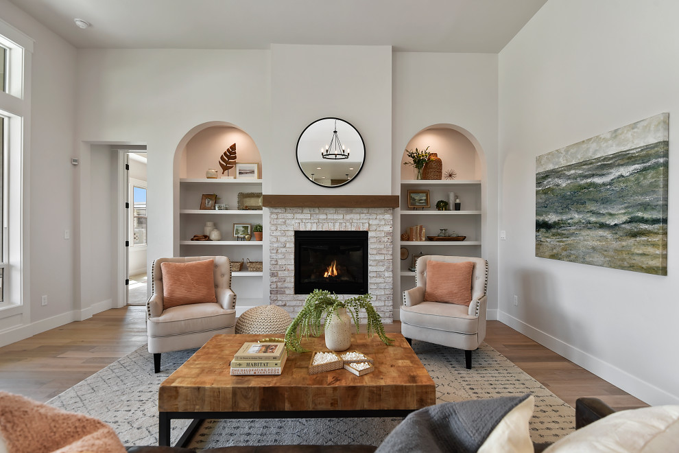 Inspiration for a medium sized traditional formal open plan living room in Boise with beige walls, light hardwood flooring, a standard fireplace, a brick fireplace surround, no tv and brown floors.