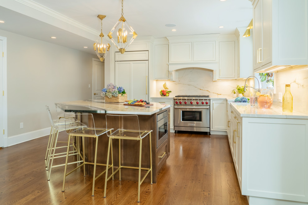 Inspiration for a large transitional kitchen remodel in New York with shaker cabinets, marble countertops and an island