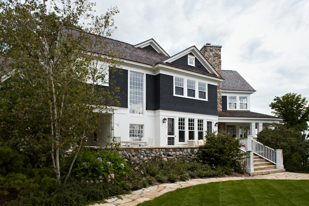 This is an example of a beach style two-storey black exterior in Chicago.
