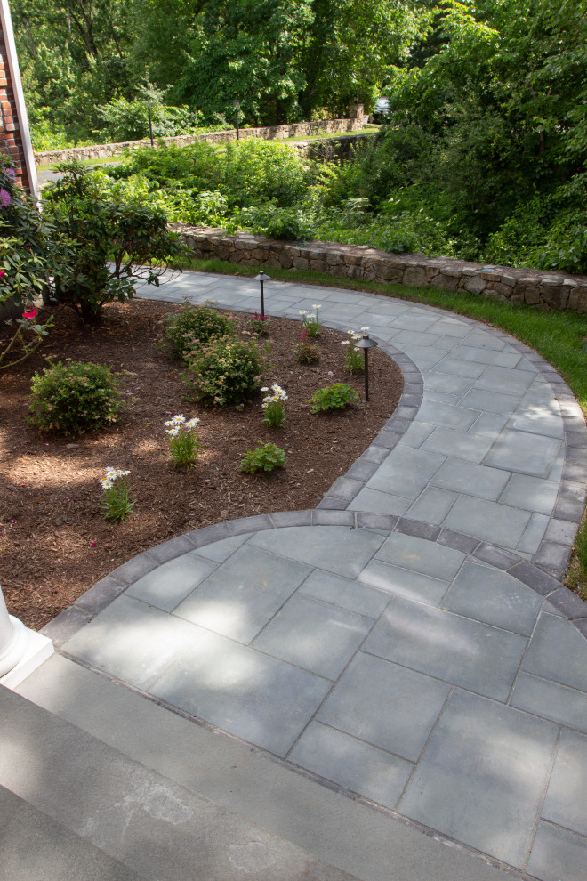 Photo of a medium sized traditional front partial sun garden in Boston with a pathway.
