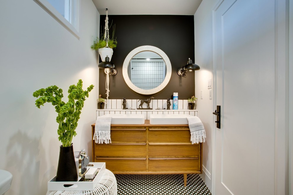 This is an example of a small transitional 3/4 bathroom in Toronto with flat-panel cabinets, medium wood cabinets, an alcove tub, a shower/bathtub combo, a two-piece toilet, white tile, ceramic tile, white walls, mosaic tile floors, a vessel sink, wood benchtops, multi-coloured floor and a shower curtain.
