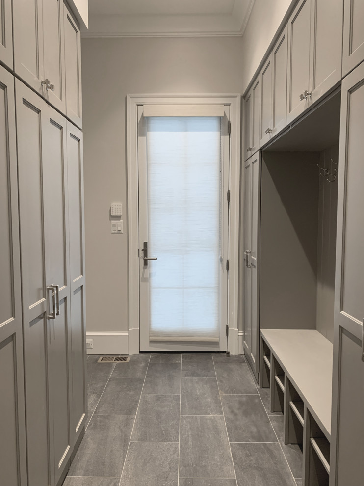 Design ideas for a mid-sized transitional mudroom in DC Metro with beige walls, porcelain floors, a single front door, a dark wood front door and grey floor.