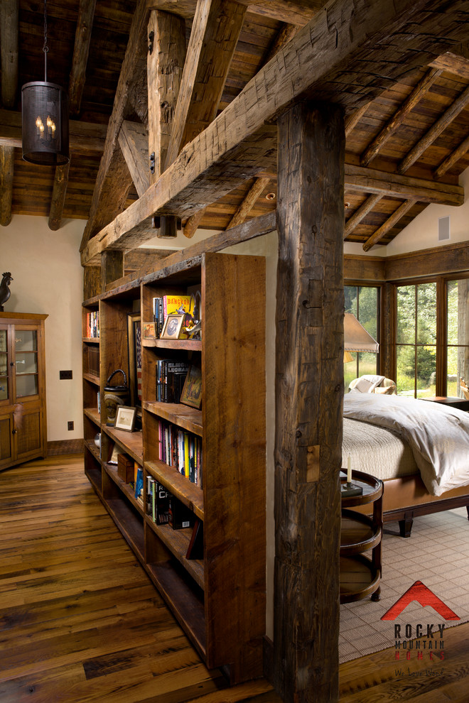 Design ideas for a mid-sized country bedroom in Other with light hardwood floors and beige walls.