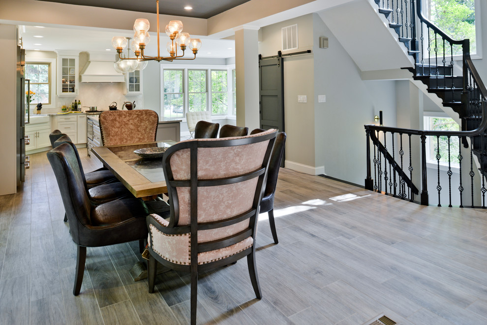 Design ideas for a large transitional kitchen/dining combo in DC Metro with laminate floors and brown floor.