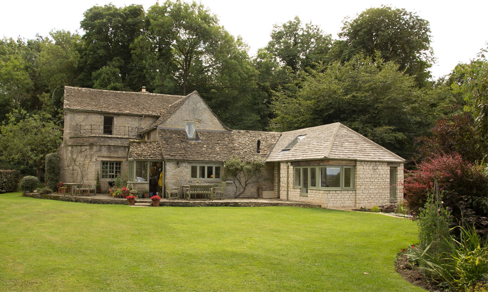 Inspiration for a mid-sized traditional one-storey exterior in Gloucestershire with stone veneer.