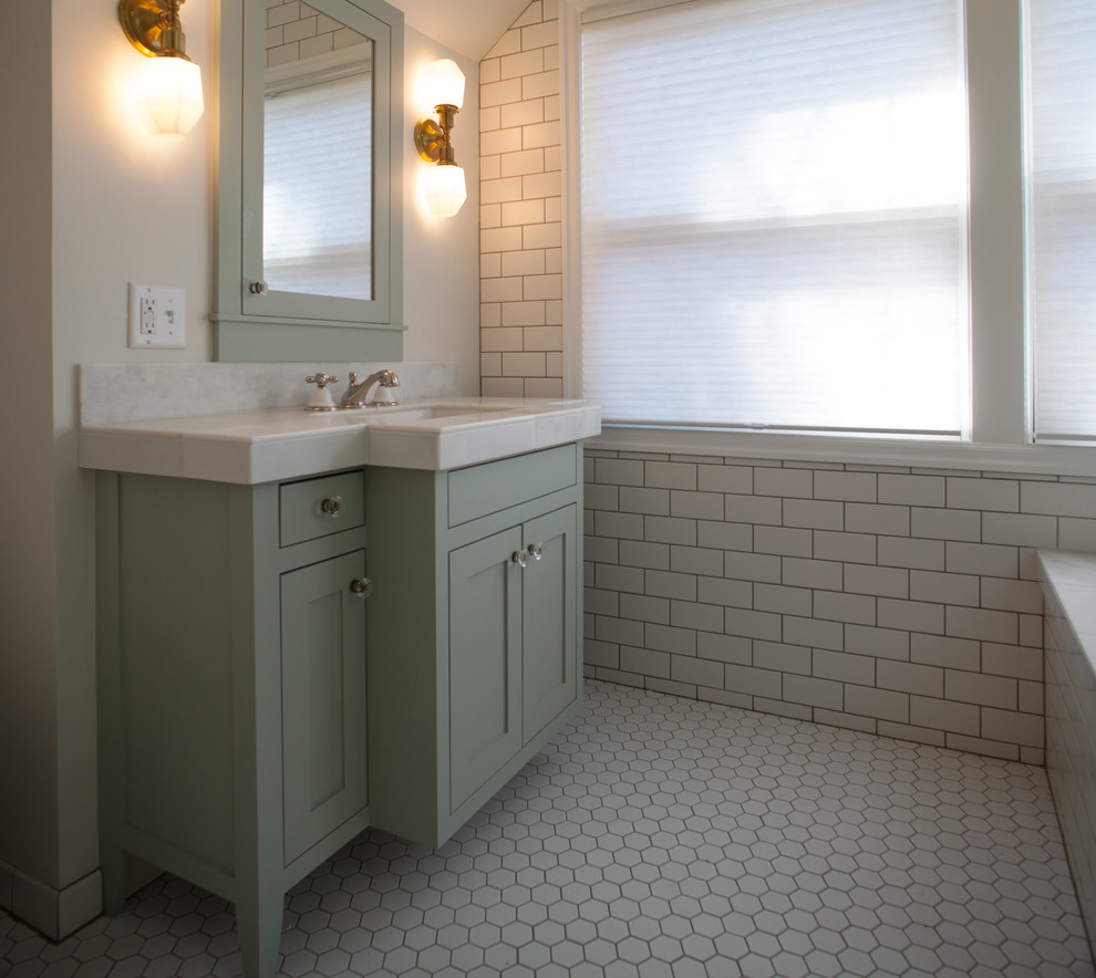 Inspiration for a small traditional master bathroom in Portland with shaker cabinets, green cabinets, a corner tub, a corner shower, a one-piece toilet, white tile, subway tile, white walls, mosaic tile floors, an integrated sink and solid surface benchtops.