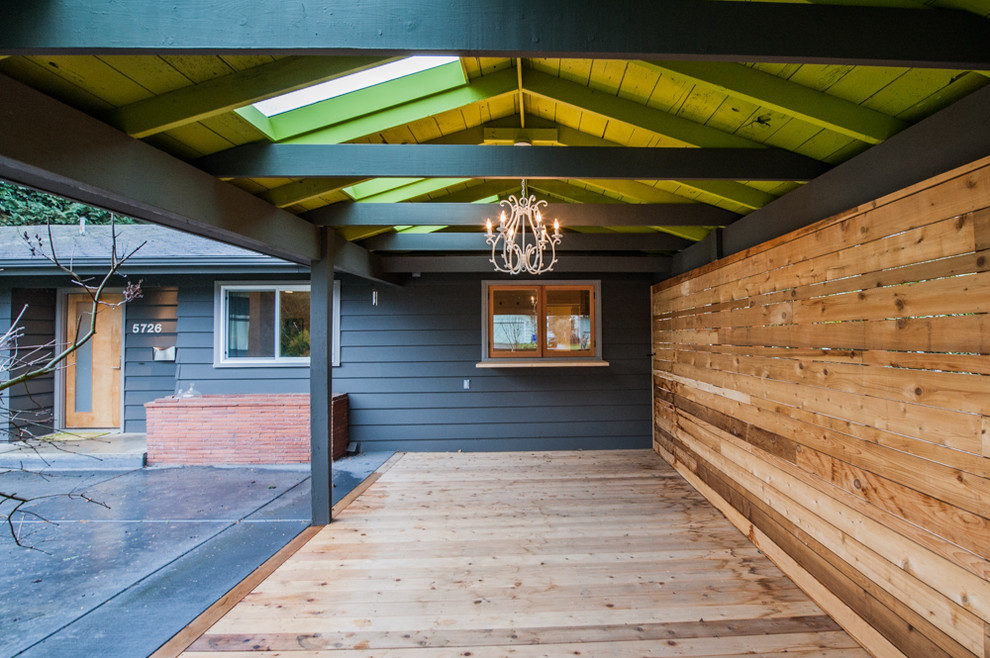 Photo of a midcentury front yard patio in Portland with decking and a roof extension.
