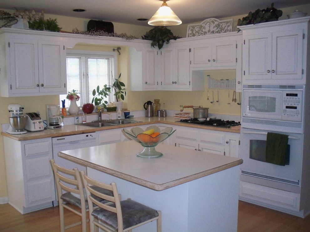 Inspiration for a mid-sized transitional kitchen remodel in Chicago with recessed-panel cabinets, white cabinets and two islands