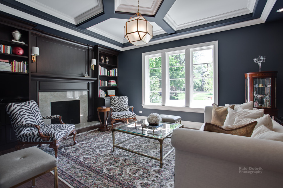 Inspiration for a contemporary family room in Chicago with grey walls, medium hardwood floors, a standard fireplace, a wood fireplace surround and a wall-mounted tv.