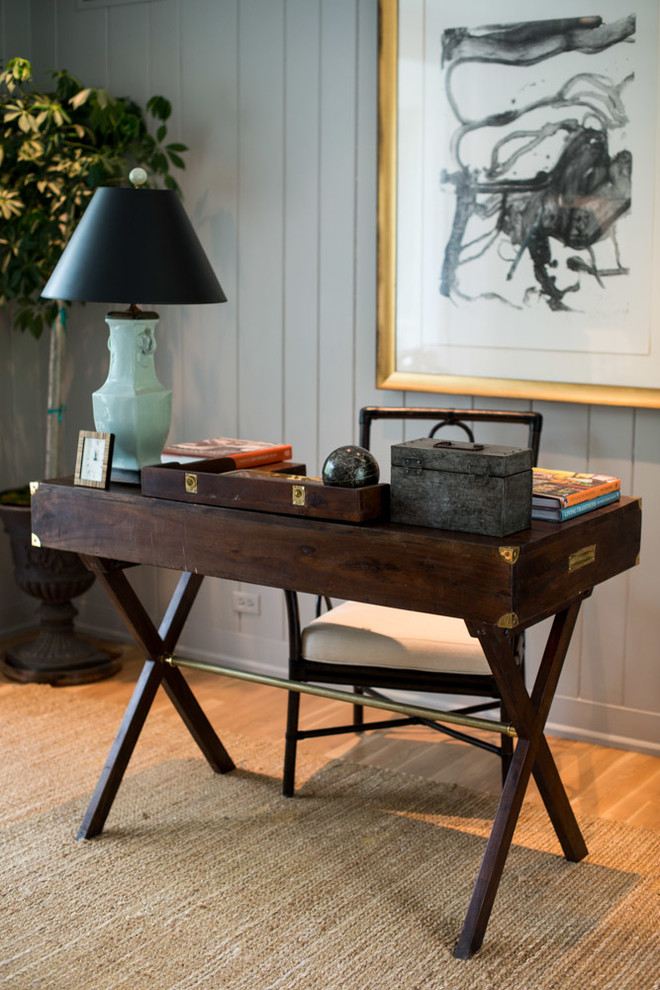 Traditional home office in Other with grey walls, medium hardwood floors and a freestanding desk.