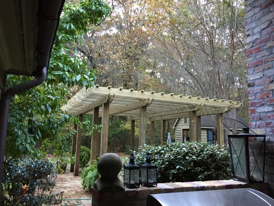 Inspiration for a mid-sized transitional backyard concrete patio remodel in Jackson with a pergola