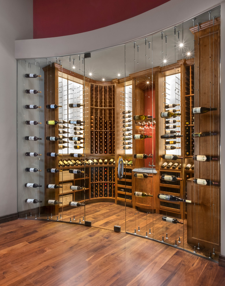 Photo of a contemporary wine cellar in Phoenix with medium hardwood floors and storage racks.
