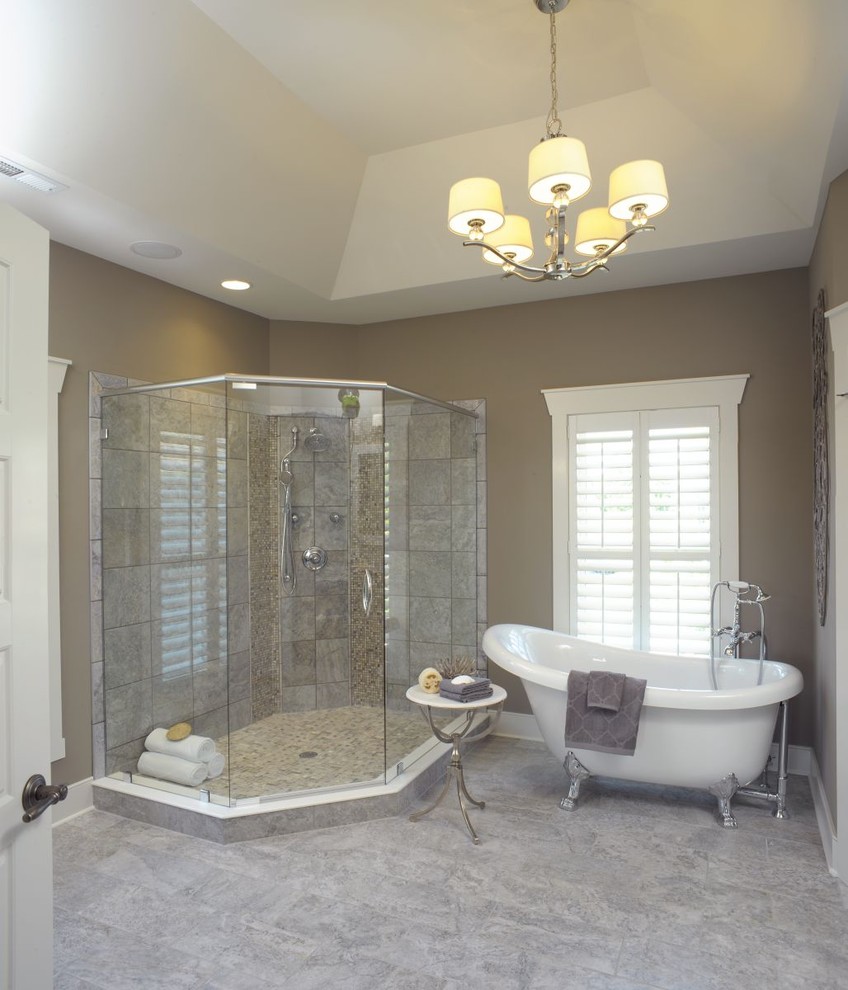 Beach style master bathroom in Columbus with raised-panel cabinets, blue cabinets, a claw-foot tub, a corner shower, an undermount sink, grey floor, a hinged shower door, a double vanity, a built-in vanity and grey walls.