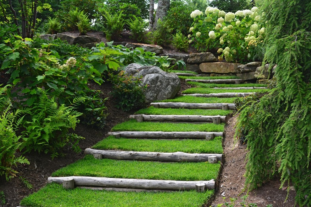 Photo of a large traditional sloped partial sun garden in Other.