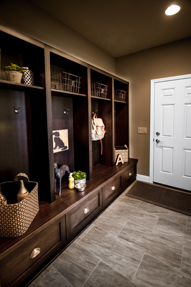 Example of a mid-sized transitional ceramic tile and gray floor mudroom design with beige walls and a white front door