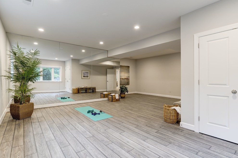 This is an example of a large transitional home yoga studio in DC Metro with beige walls, vinyl floors and brown floor.