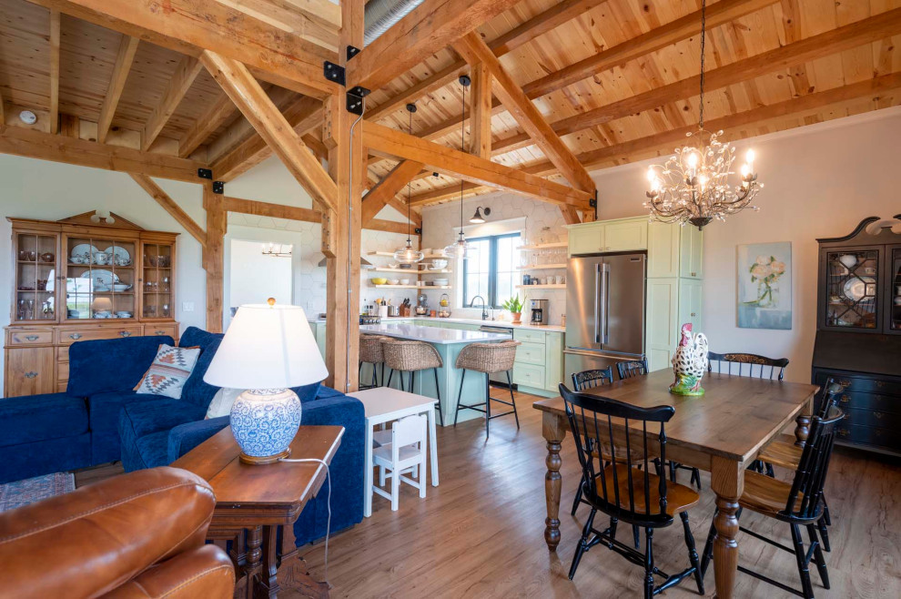 Open concept kitchen - mid-sized rustic l-shaped light wood floor, brown floor and vaulted ceiling open concept kitchen idea with a farmhouse sink, granite countertops, white backsplash, stainless steel appliances, an island and white countertops