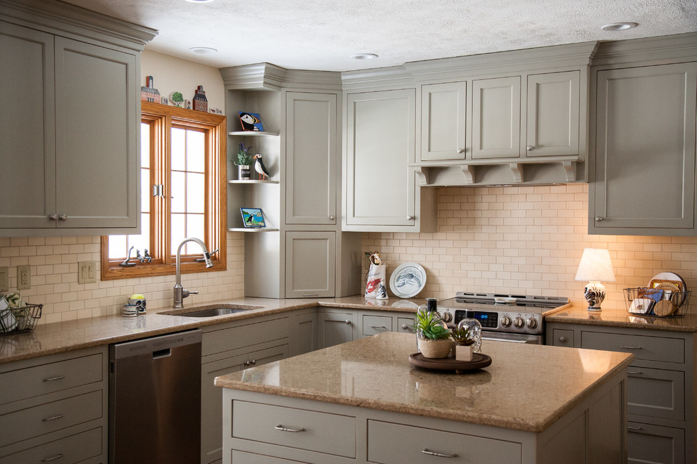 Eat-in kitchen - mid-sized transitional u-shaped medium tone wood floor eat-in kitchen idea in Cleveland with an undermount sink, flat-panel cabinets, gray cabinets, quartz countertops, beige backsplash, ceramic backsplash, stainless steel appliances and an island