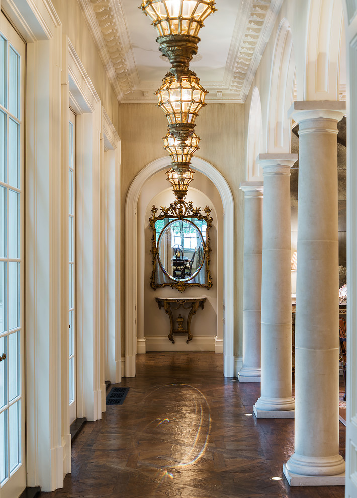 Inspiration for a traditional hallway in Dallas with beige walls, dark hardwood floors and brown floor.