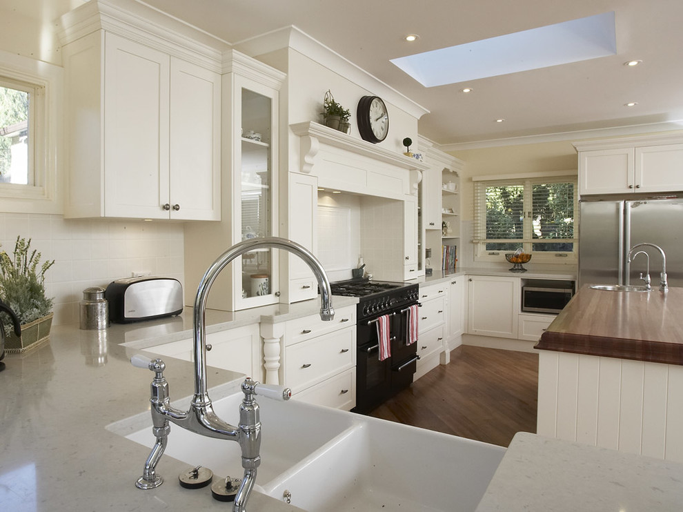 Design ideas for a traditional kitchen in Other with recessed-panel cabinets and a farmhouse sink.