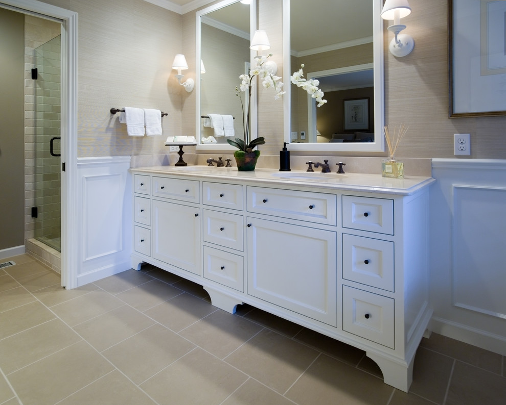 Traditional bathroom in Portland with recessed-panel cabinets, white cabinets, a corner shower and beige tile.