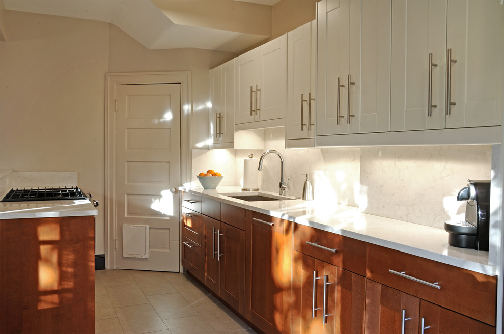 Mid-sized transitional galley porcelain tile eat-in kitchen photo in DC Metro with an undermount sink, shaker cabinets, medium tone wood cabinets, quartzite countertops, white backsplash, stone tile backsplash, stainless steel appliances and beige walls