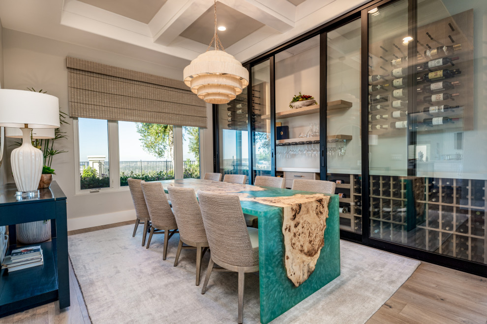 Photo of a mid-sized beach style separate dining room in Orange County with grey walls, light hardwood floors, beige floor and coffered.