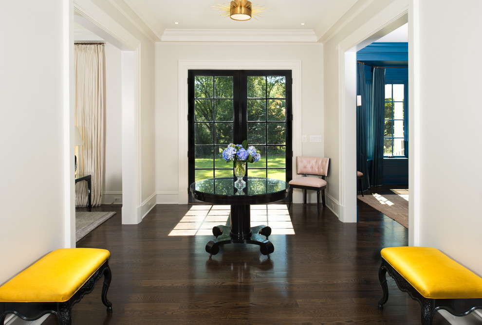 Photo of a transitional entryway in DC Metro with white walls, dark hardwood floors, a double front door and a glass front door.