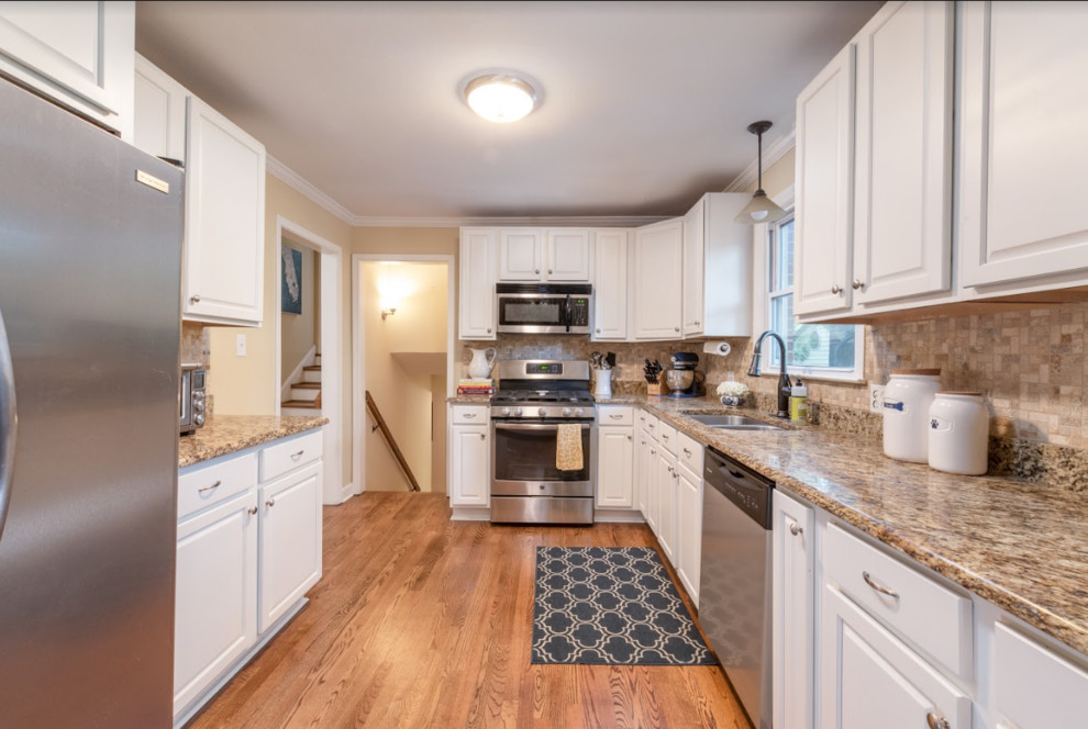 Kitchen - small transitional medium tone wood floor kitchen idea in Charlotte with beige backsplash