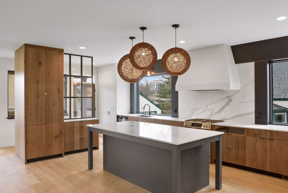 Photo of a large transitional u-shaped kitchen pantry in Minneapolis with an undermount sink, flat-panel cabinets, brown cabinets, quartz benchtops, multi-coloured splashback, marble splashback, stainless steel appliances, medium hardwood floors, with island, brown floor and white benchtop.