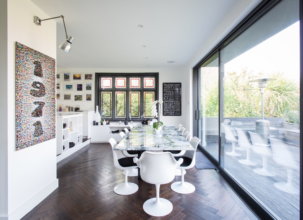Mid-sized contemporary dining room in London with white walls, dark hardwood floors, brown floor and no fireplace.