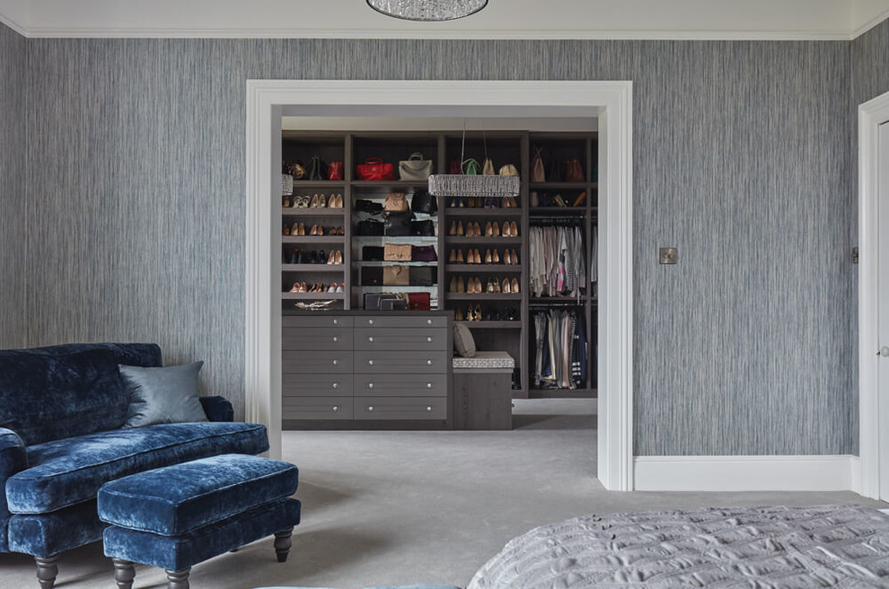 This is an example of a large contemporary master bedroom in Manchester with grey walls, carpet and grey floor.